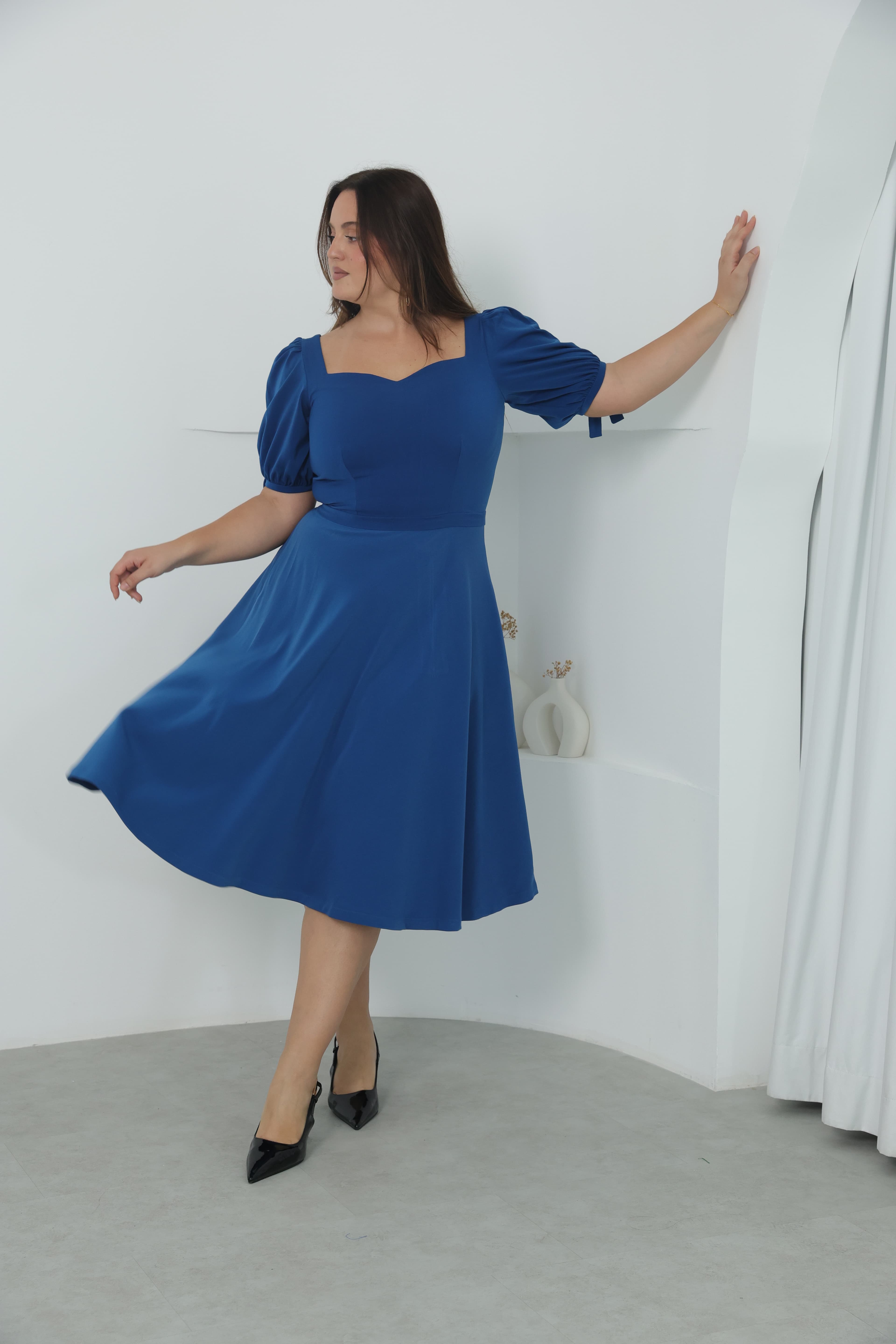 Model in tailored neutral outfit showcasing British-inspired design